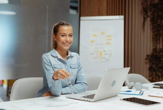 adult-female-holding-glasses-in-front-of-laptop