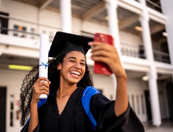 graduate-holding-diploma-taking-selfie